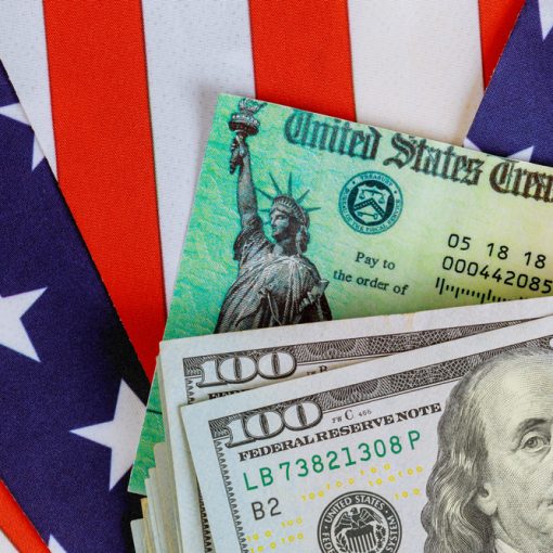 The picture shows US dollars and treasury bill in the backdrop of the flag