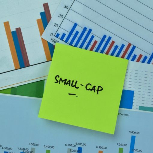This is an image of small cap written on stick note atop charts