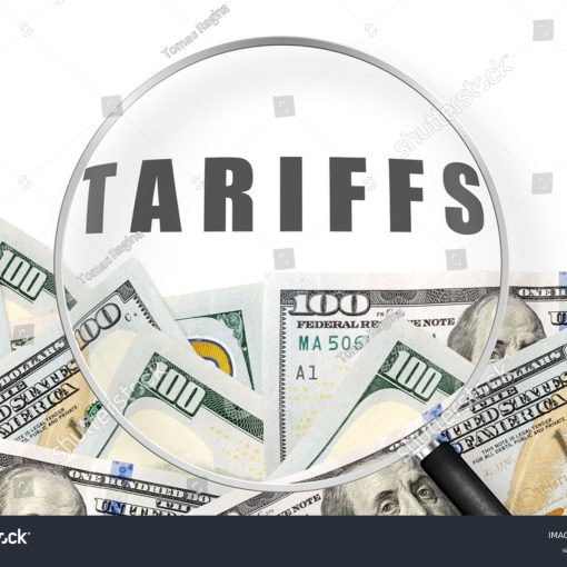 The image shows Dollars Notes With Word Tariffs Through Magnifying Glass
