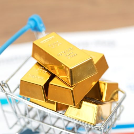 The image shows gold bars in a shopping cart