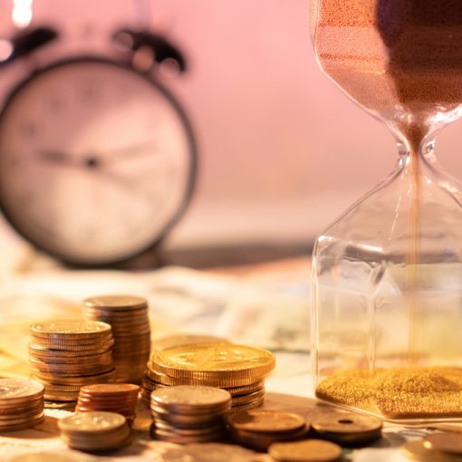 This a is a picture of an hourglass with money