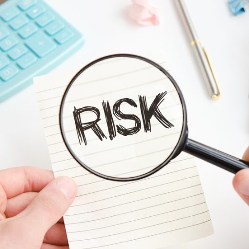 The image shows risk text on paper