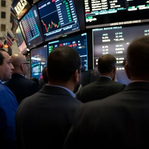 The image shows traders watching markets