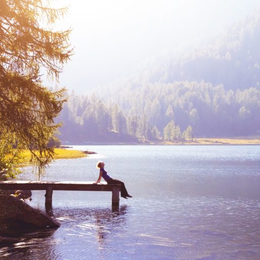 The image shows a happy person at a lake