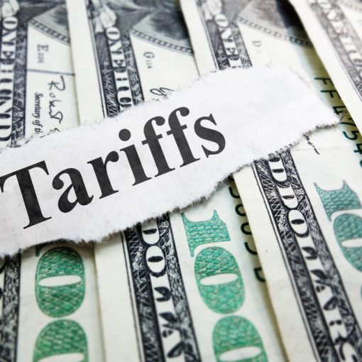 The image shows the headline tariff on dollar bills