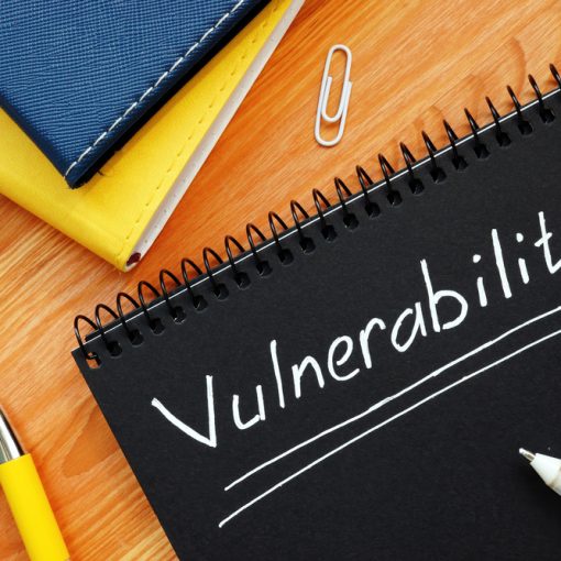 The word vulnerability written on a black paper