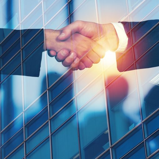 The image shows business partners doing a handshake