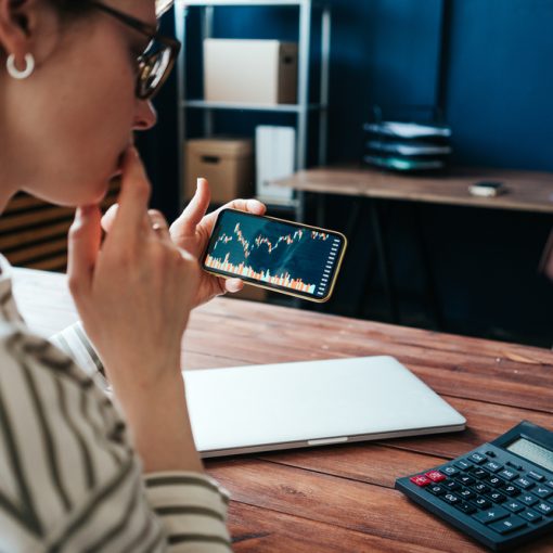 The image shows an investor watching the market trends and thinking