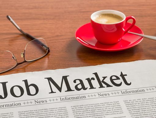 The image shows a newspaper with job market news