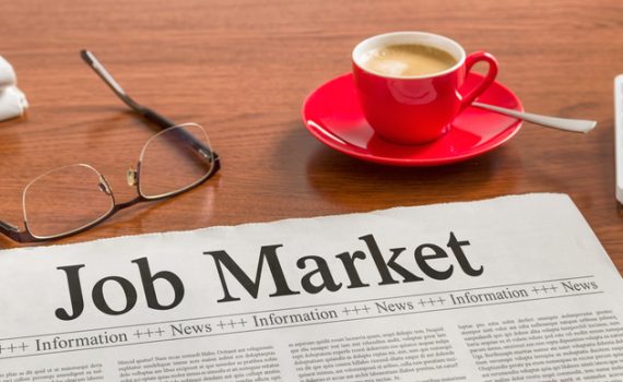 The image shows a newspaper with job market news