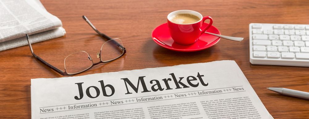 The image shows a newspaper with job market news