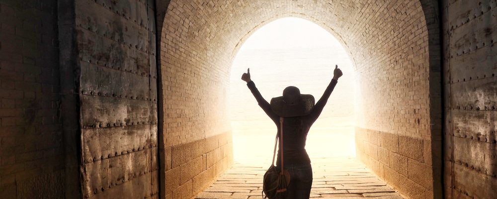 The image shows a person seeing light at the end of tunnel