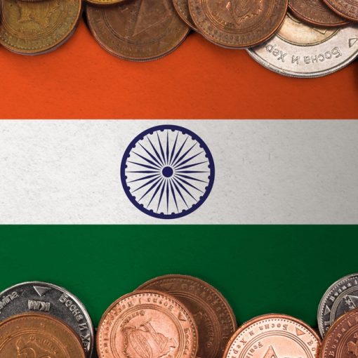 The image shows coins on a flag of India