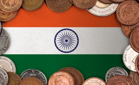 The image shows coins on a flag of India