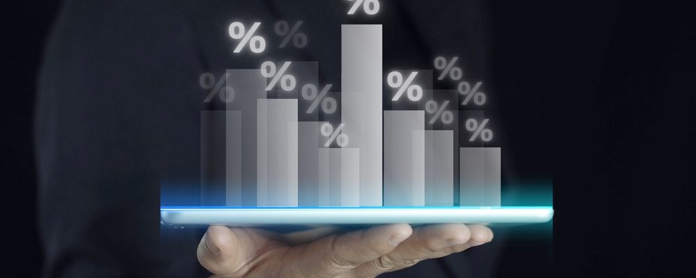 The image shows a hand holding Market Sales Charts in Black
