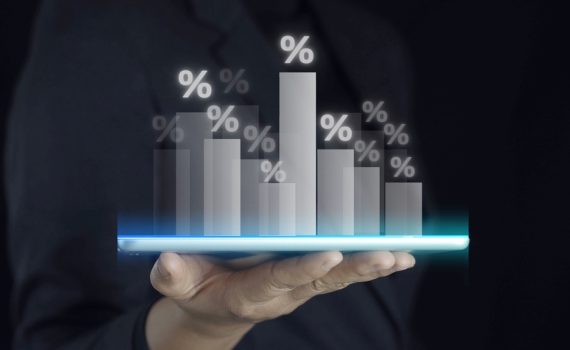 The image shows a hand holding Market Sales Charts in Black
