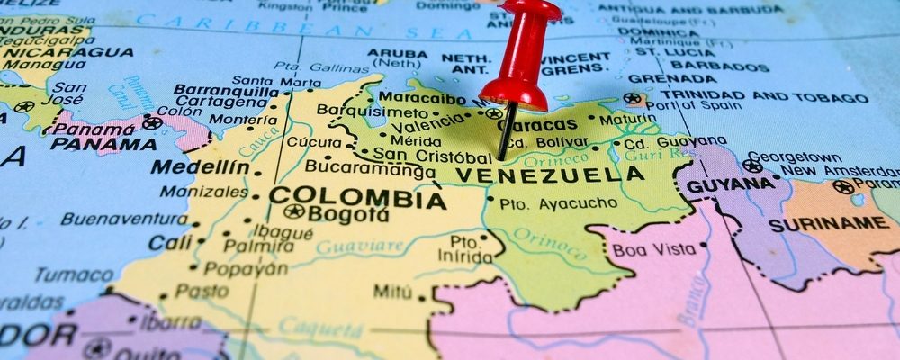 The image shows a pushpin marking Venezuela on map