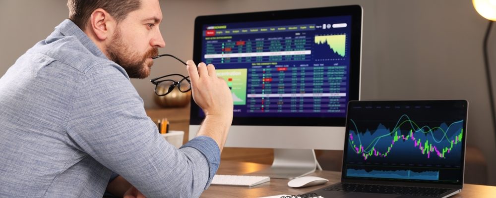 The image shows a Man doing Analysis Financial Market Charts