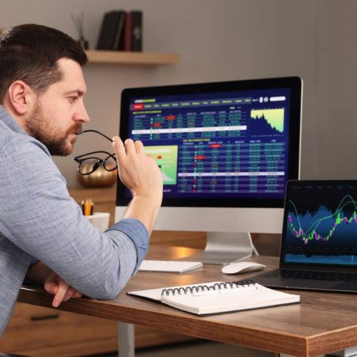 The image shows a Man doing Analysis Financial Market Charts