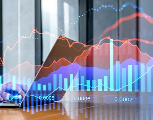 Laptop with charts in background