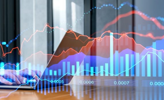 Laptop with charts in background