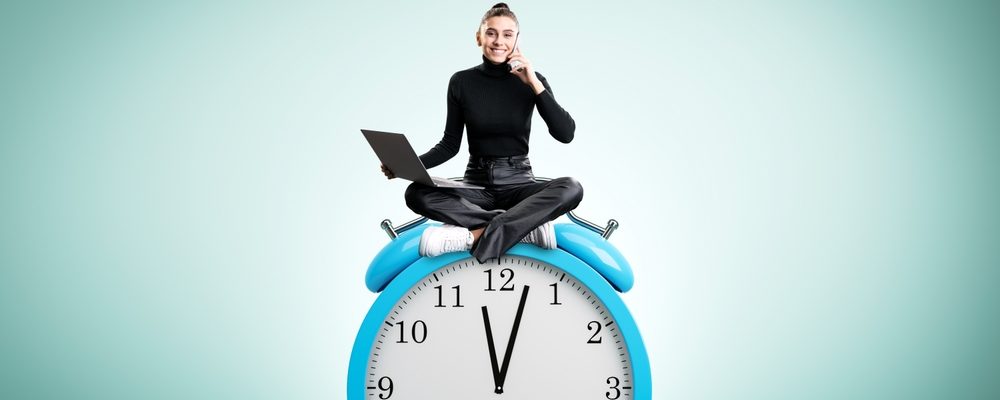 Woman Sitting on a Clock with Laptop