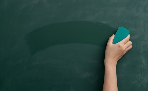 Hand with Duster Erasing Chalkboard