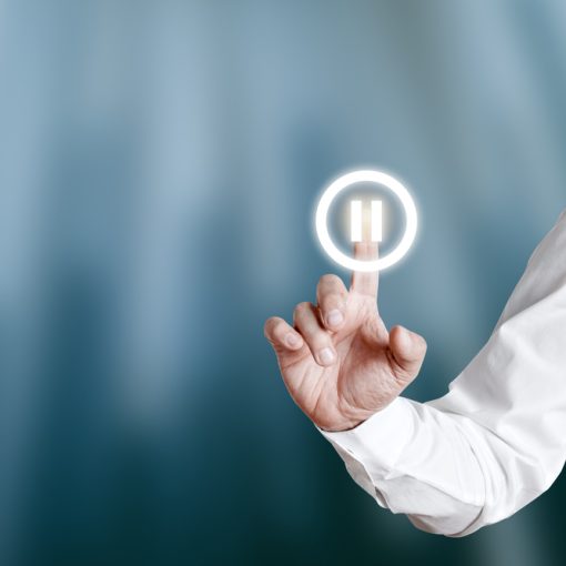 Pause Button being pressed by Businessman on Virtual Screen